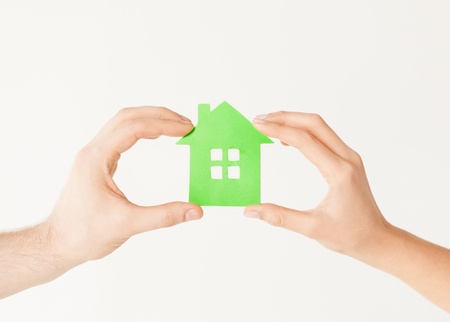 closeup picture of woman and man hands holding green houseの写真素材