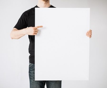 close up of man hands showing white blank board