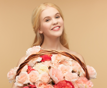 picture of young woman with basket full of flowers の写真素材