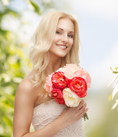 close up of young woman with bouquet of flowersの写真素材