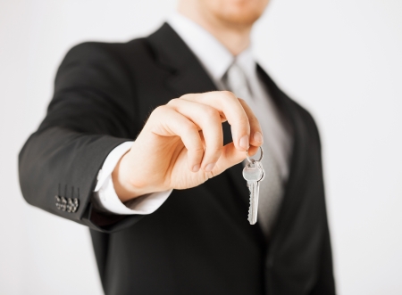 bright picture of man hand holding house keysの写真素材