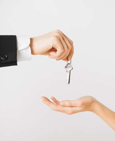 picture of man hand passing house keys to womanの写真素材