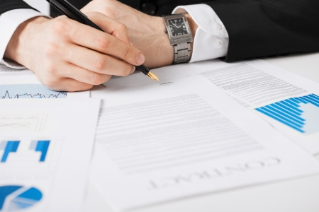 close up picture of man hand signing contractの写真素材