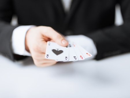 close up of man hand showing four acesの写真素材