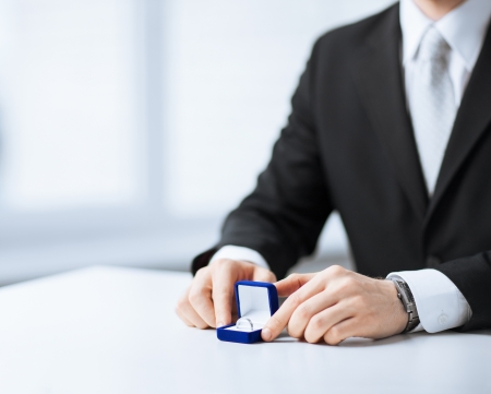 picture of man with gift box and wedding ringの写真素材