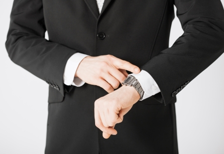 close up of man looking at wristwatchの写真素材