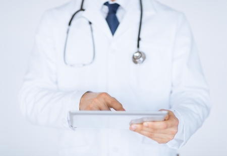 close up of male doctor holding tablet pcの写真素材
