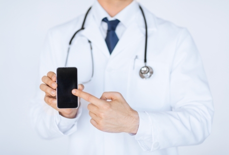 close up of male doctor pointing at smartphoneの写真素材