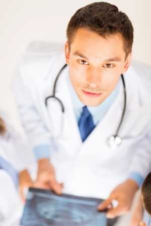 bright picture of male doctor with x-rayの写真素材