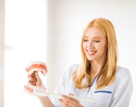 smiling female doctor with big jaws and toothbrush  