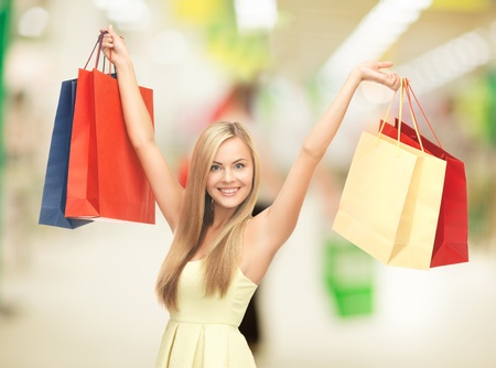 happy woman with shopping bags at the mallの写真素材