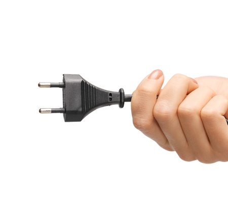 close up of hand holding black electrical plug with wire