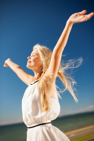 lifestyle concept - beautiful woman enjoying summer outdoorsの写真素材