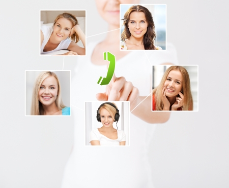 technology and communication - woman pressing button on virtual screen with contact iconsの写真素材