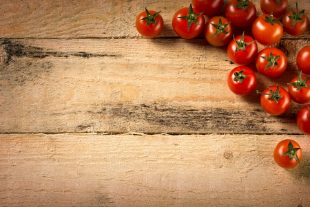 food and cooking concept - cherry tomatoes on wood backgroundの写真素材