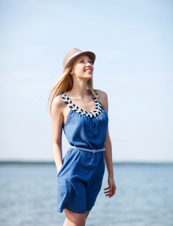summer holidays and vacation - girl in hat walking on the beachの写真素材