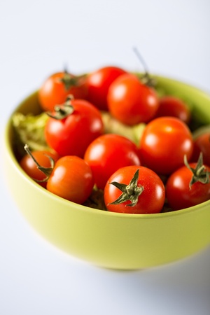 food and cooking concept - cherry tomatoes in bowlの写真素材