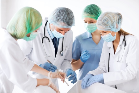 healthcare and medical - young group of doctors doing operationの写真素材