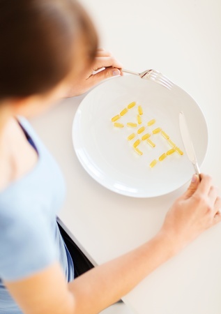 sport, healthcare and diet concept - woman with plate and medsの写真素材