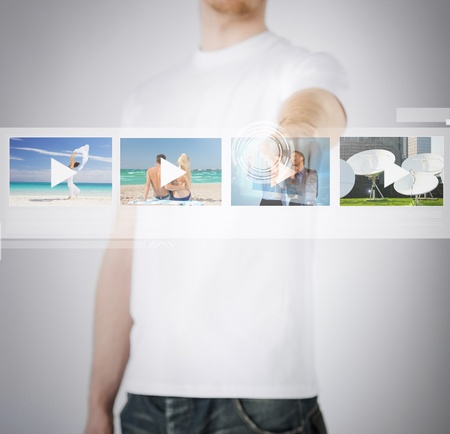 technology, internet and networking concept - man pressing button on virtual screenの写真素材