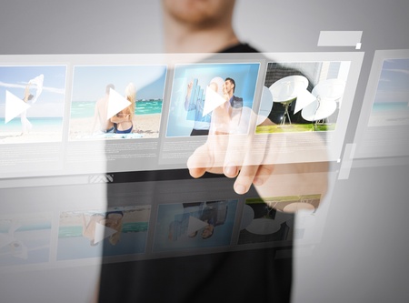 technology, internet and networking concept - man pressing button on virtual screenの写真素材