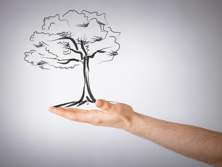 environment, ecology and nature protection concept - man with small tree in his handの写真素材