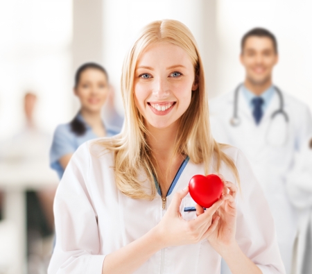 healthcare and medical concept - female doctor with heartの写真素材