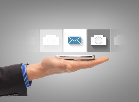 business, future technology and internet - hand with smartphone showing instant picture applicationの写真素材