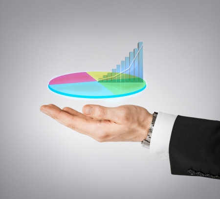 business and finances - businessman hand showing raising virtual chartの写真素材