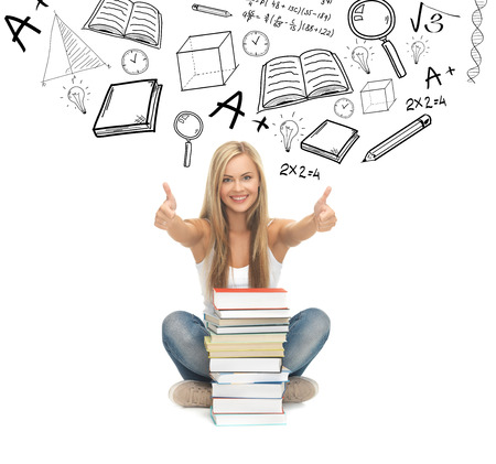 education and school concept - picture of smiling student with stack of booksの写真素材
