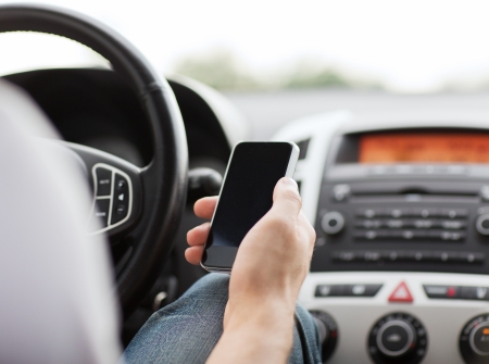 transportation and vehicle concept - man using phone while driving the car