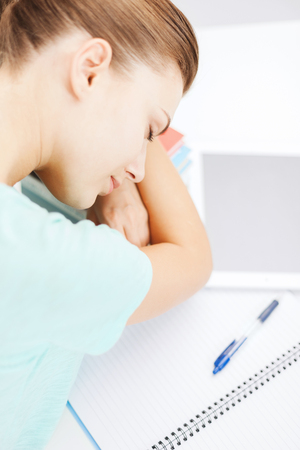 business, office, school and education concept - tired student sleeping on stock of booksの写真素材
