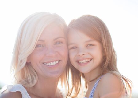 summer holidays, family, children and people concept - happy mother and child girlの写真素材