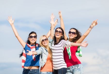 summer, holidays, vacation, happy people concept - beautiful teenage girls or young women having fun on the beachの写真素材