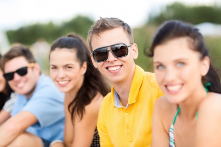 summer, holidays, vacation, happy people concept - group of friends having fun on the beachの写真素材
