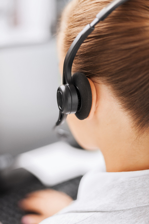 business, office, school and education concept - female helpline operator with headphonesの写真素材