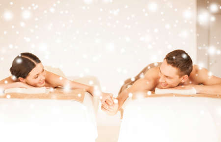 health and beauty, love, romance concept - couple in spa salon drinking champagneの写真素材