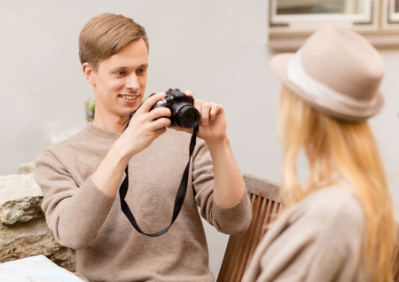summer holidays and dating concept - couple taking photo picture at cafe in the cityの写真素材