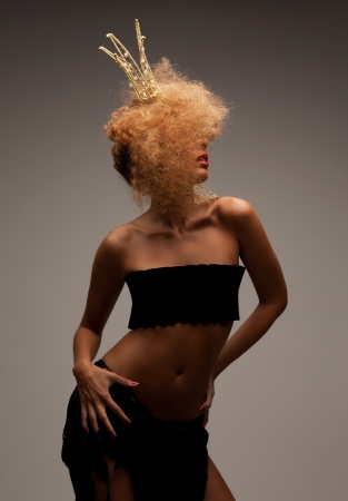 beaut, glamour and helloween concept - woman with long curly hair in crownの写真素材