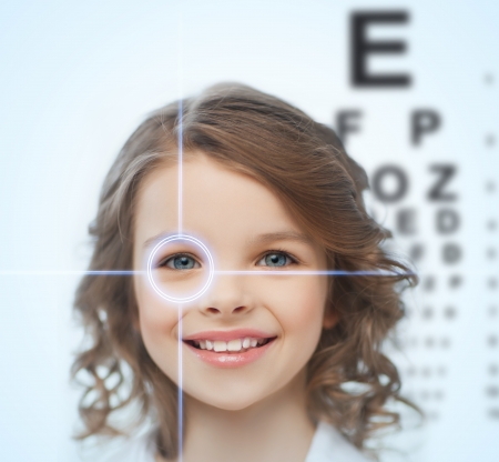 health, vision, medicine, laser correction, happy people concept - smiling pre-teen girl with optometric table or eyesight testing boardの写真素材