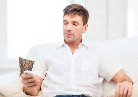 business, communication, modern technology concept - buisnessman with smartphoneの写真素材