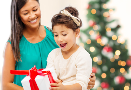 holidays, presents, christmas, x-mas, birthday concept - happy mother and child girl with gift boxの写真素材