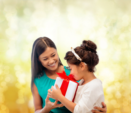 holidays, presents, christmas, x-mas, birthday concept - happy mother and child girl with gift boxの写真素材
