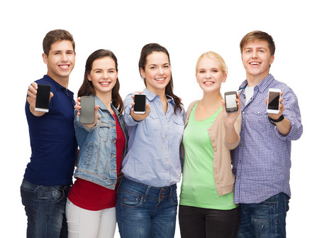 education and modern technology concept - smiling students showing blank smartphones screens