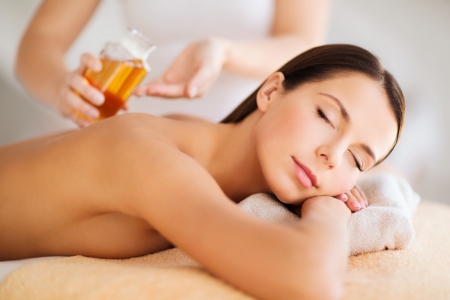 beauty, spa, resort and relaxation concept - beautiful woman in spa salonの写真素材