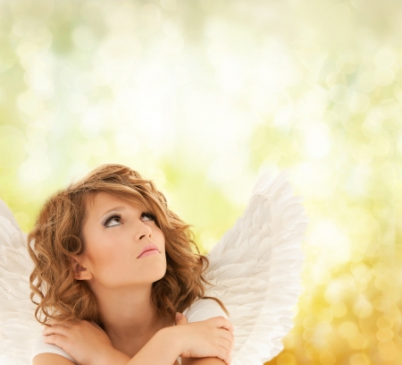 holidays, love and costumes concept - unhappy teenage angel girlの写真素材