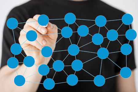 communication and networking concept - closeup of man drawing social or business network on virtual scneenの写真素材