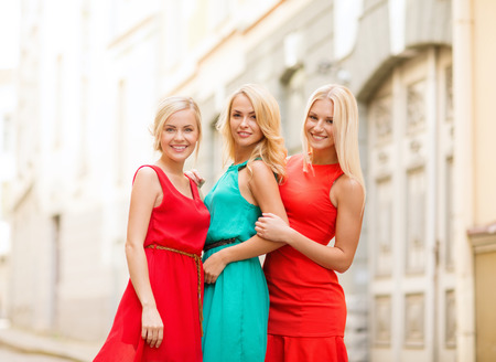 holidays and tourism, friends, hen party and blonde girls concept - three beautiful women in the cityの写真素材