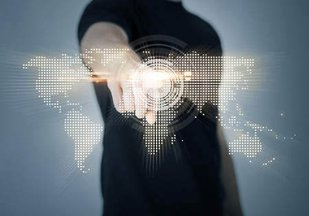 communication concept - closeup of man pointing his finger at world mapの写真素材