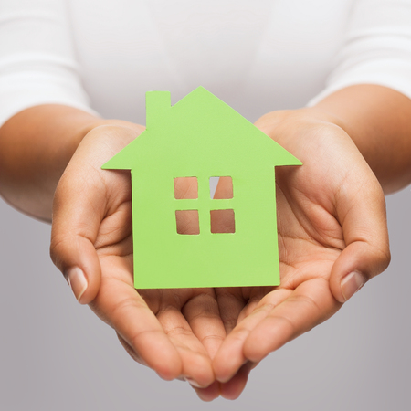 closeup picture of woman hands holding green houseの写真素材